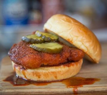 Nashville Hot Chicken · Fried chicken breast, teds bread and butter pickles on a brioche bun drizzled with spicy pepper oil