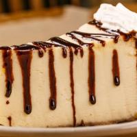 New York Cheesecake · Drizzled with choice of chocolate or strawberry topping.