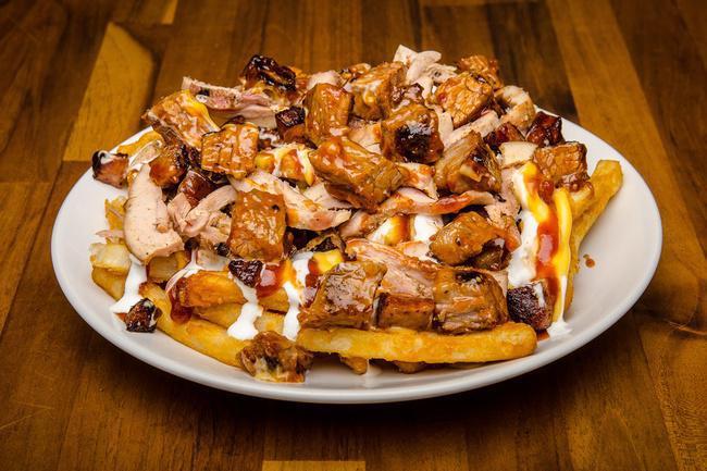 Loaded Fries - Hat Trick · All Loaded Fries start off with ¾ lb. of fries and at least ¼ lb. of Meat, this one has THREE meats; Cajun Sausage - Sliced Chicken - Brisket Chunks for a total of ¾ lb. Topped with; BBQ Sauce - Cheese Sauce - Sour Cream.