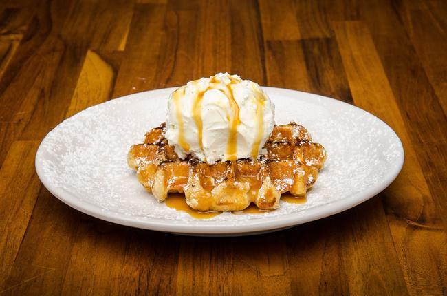 Dessert - Waffle & Ice Cream · ONE Pearl Sugar Belgian Waffle cooked to perfection - topped off with creamy real Vanilla Bean Ice Cream and drizzled with Caramel Syrup and powdered Sugar.