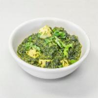 Saag Paneer · Spinach cooked with cubes of cottage cheese delicately spiced and garnished with chopped gin...