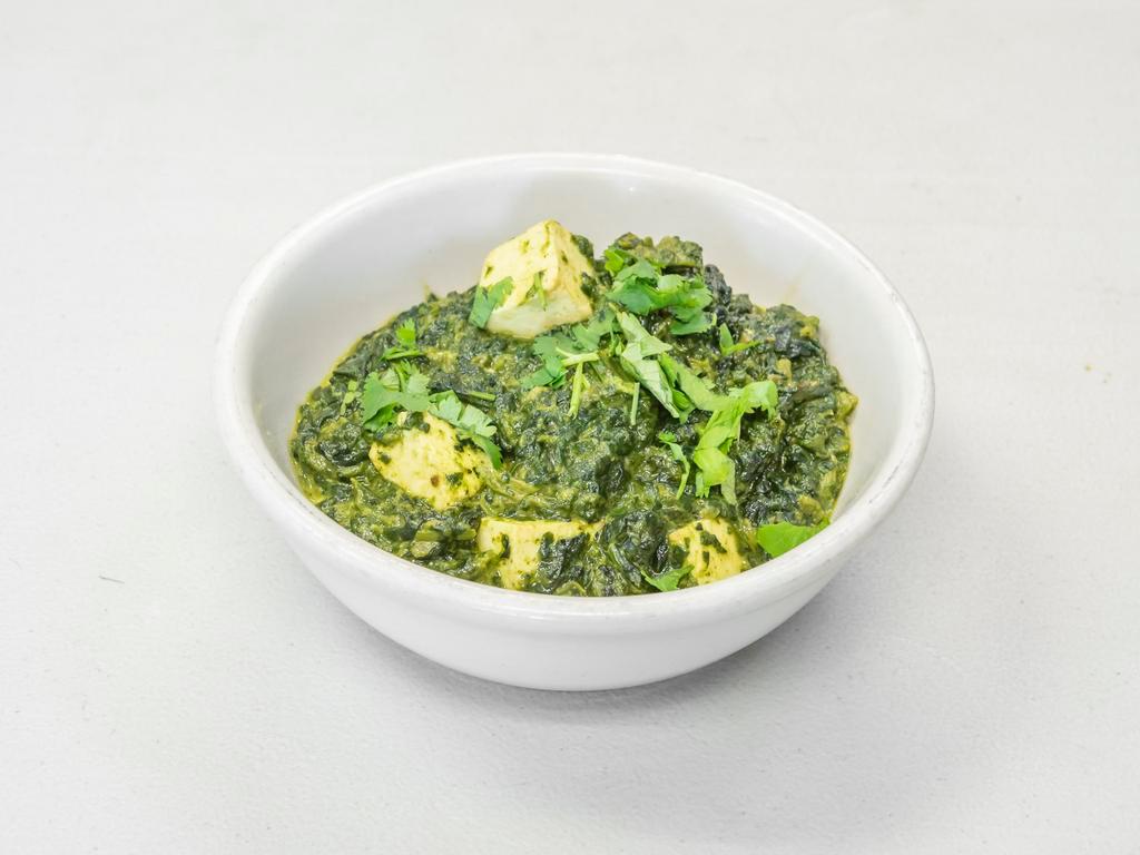 Saag Paneer · Spinach cooked with cubes of cottage cheese delicately spiced and garnished with chopped ginger.