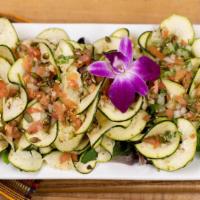The Zingy Salad · Zucchini spirals, yuzu, tomato, onion, cilantro, pumpkin seeds, jalapeno and sesame seeds.