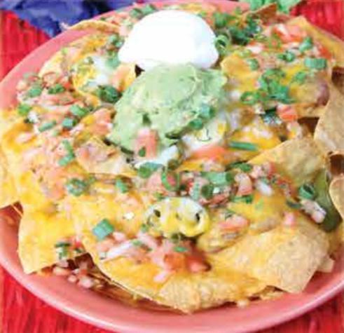 Nachos Fiesta · Crisp corn tortilla chips topped with beans, jalapenos and melted cheddar cheese. Garnished with tomatoes, green onions, sour cream, pico de gallo and guacamole.