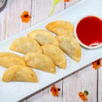 3. Fried Wonton · Crispy deep-fried wonton stuffed with ground chicken and served with sweet and sour sauce.