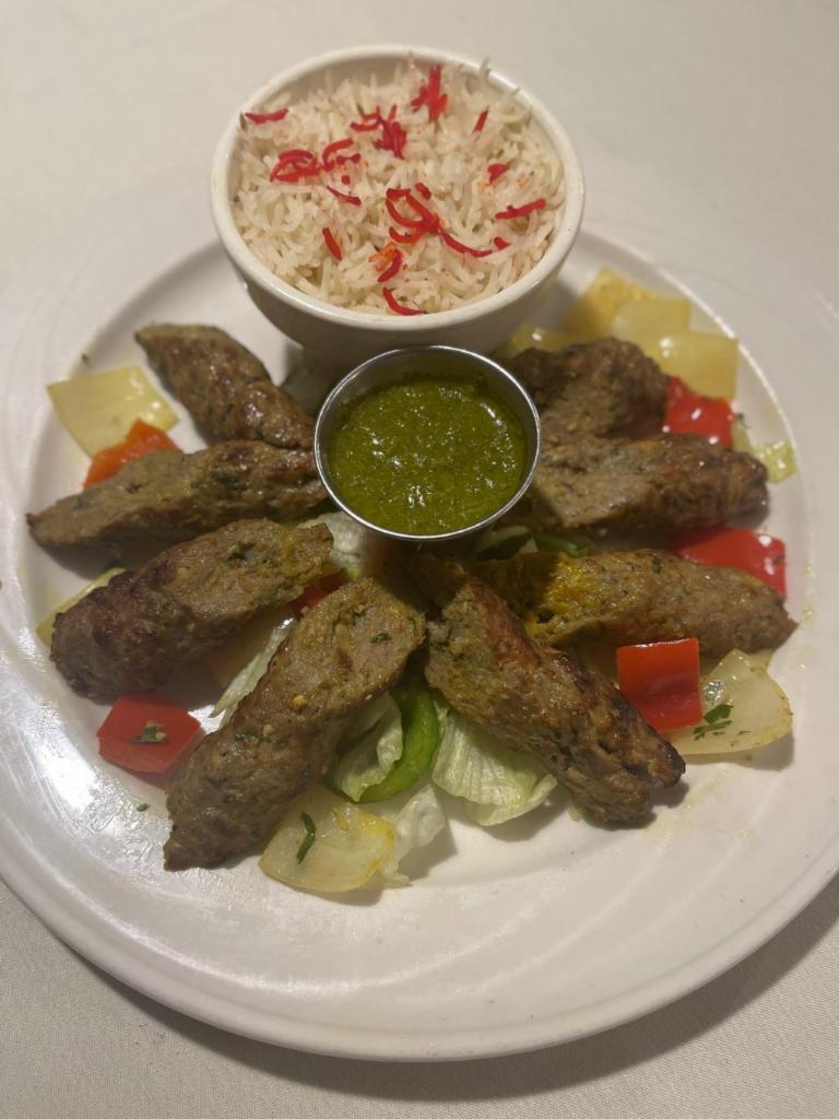 Boti (lamb) kebab  · Ground meat with ginger, garlic, onion, seasonings & herbs, roasted to perfection in our clay oven served with a salad of cucumber, tomato and onion,chutney and basmati rice