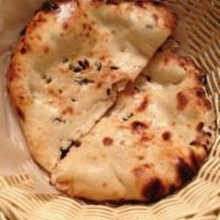 Kashmiri Naan · Soft white bread stuffed with raisins, cashews, and coconut.

