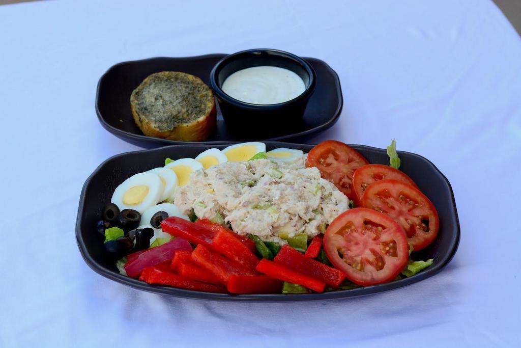 Albacore Tuna Salad · Tuna Salad (albacore tuna, celery, fine-diced red onion, mayo), hard-boiled egg, romaine, tomato, red bell pepper, black olive,  garlic bread, choice of dressing (on the side).