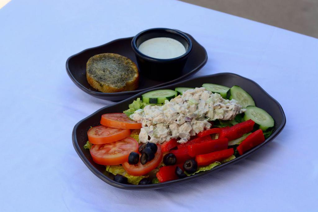 Almond Chicken Salad · Chicken salad (chicken breast, celery, fine-diced red onion, almond, mayo), romaine, tomato, cucumber, red bell pepper, black olive, garlic bread, choice of dressing (on the side).