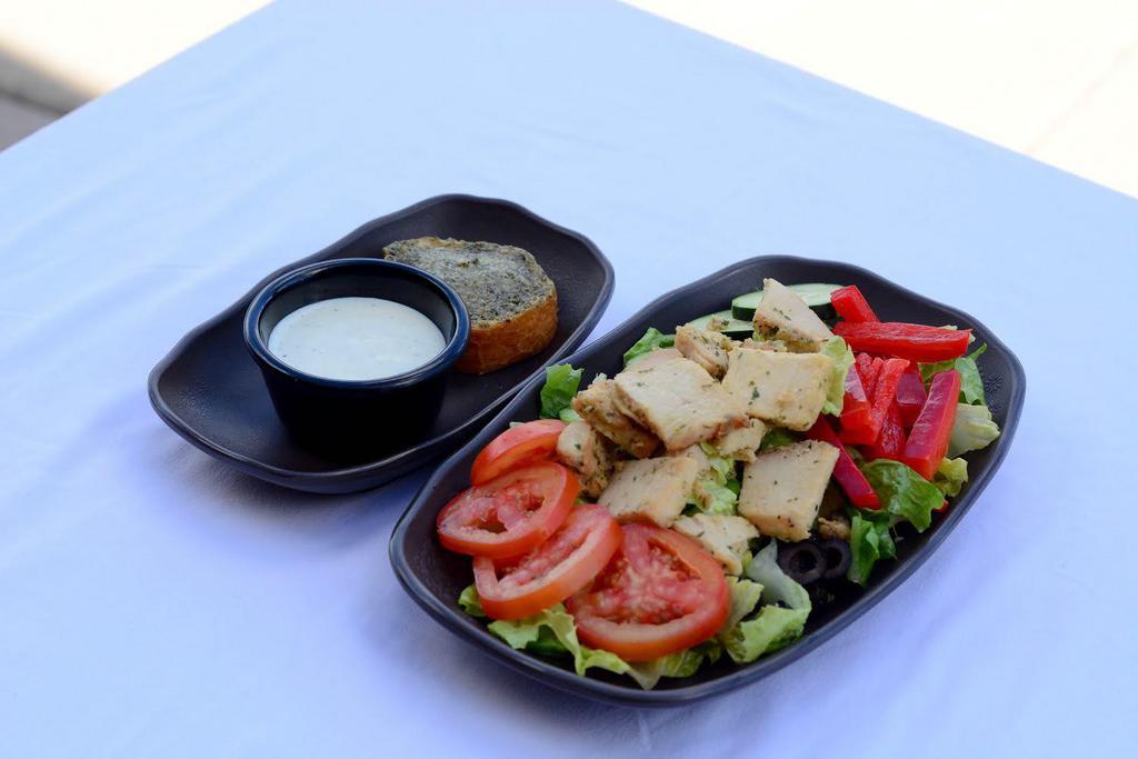 Grilled  Chicken Salad · Grilled chicken breast, romaine, tomato, cucumber, red bell pepper, black olive, garlic bread, choice of dressing (on the side).