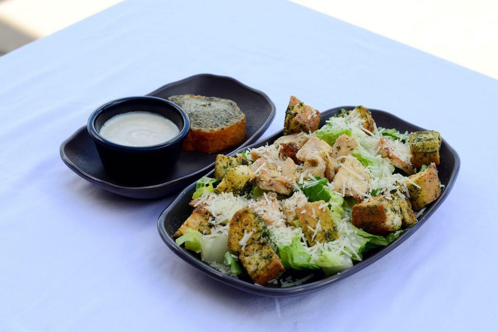 Chicken Caesar Salad · Grilled chicken breast, Parmesan cheese, romaine, crouton, garlic bread, Caesar dressing (on the side).