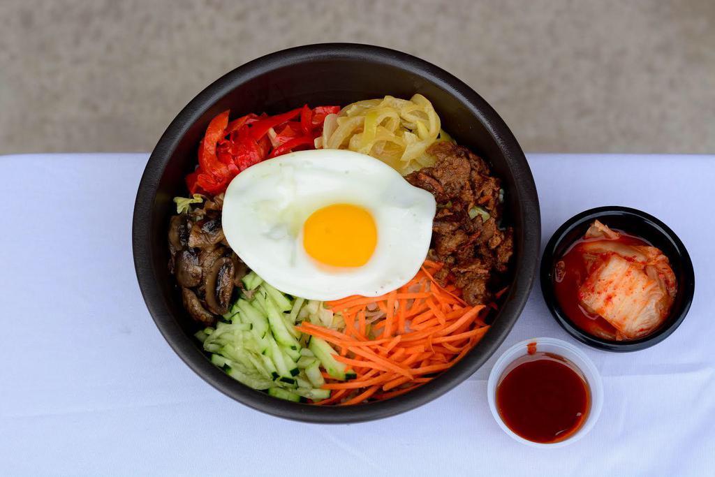 Bibimbap · Fried egg, bulgoki, grilled mushroom, grilled onion, grilled red bell pepper, carrot, cucumber, romaine; served over rice with gochujang (on the side - topped with sesame oil) and kim chi (on the side).