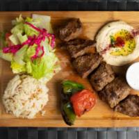 4. Beef Shish Kebab Plate · Charcoal grilled skewered beef cubes. Served with rice, salad, pita bread and hummus.