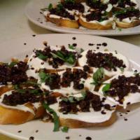 Olive Bruschetta · Crostini topped with diced olives, fresh mozzarella, balsamic glaze and extra virgin olive o...