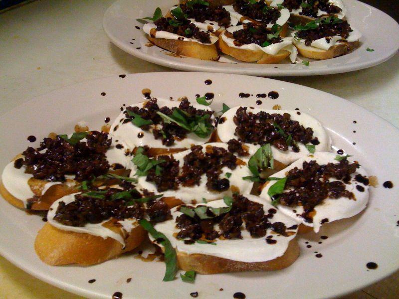 Olive Bruschetta · Crostini topped with diced olives, fresh mozzarella, balsamic glaze and extra virgin olive oil.