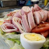 Chef Salad · Iceberg lettuce, onions, peppers, tomatoes, hard boiled egg, ham, turkey and American cheese.