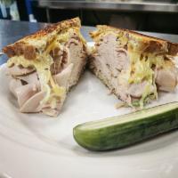 Grilled Roasted Turkey Reuben · Served on dark rye with Swiss cheese, Russian dressing and coleslaw.