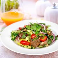 Spicy Beef Salad · Sliced grilled beef, mixed greens, lemongrass, carrots, cucumbers, tomatoes, onions and mint...
