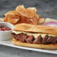 Steak Sandwich* · Sliced filet on garlic bread, prepared with béarnaise sauce, served with lettuce, tomato & o...