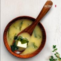 Miso Soup · A traditional savory soybean based soup with diced tofu, green onions and wakame seaweed.
