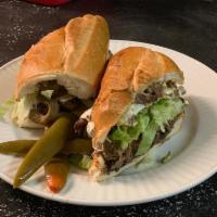 Torta Azteca · Steak, sauteed peppers, onions, cactus, lettuce and jalapenos. Served with oaxaca cheese, bl...