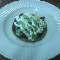 Sope · Thick round shaped corn tortilla, handmade and topped with choice of meat. Served with lettu...