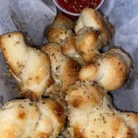 Garlic Knots · Pizza dough topped with garlic and butter. Served with a side of marinara dipping sauce.
