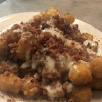 Loaded Tater Tots · Smothered with homemade chili, queso and bacon. Add sour cream for an extra charge.
