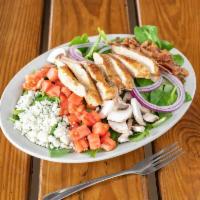 Spinach Salad · Fresh baby spinach with our citrus dressing and composed with sliced mushrooms, chopped baco...
