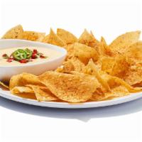 Chips ＆ Queso · It ain’t rocket surgery. It’s a creamy blend of melted cheeses mixed with roasted red and gr...