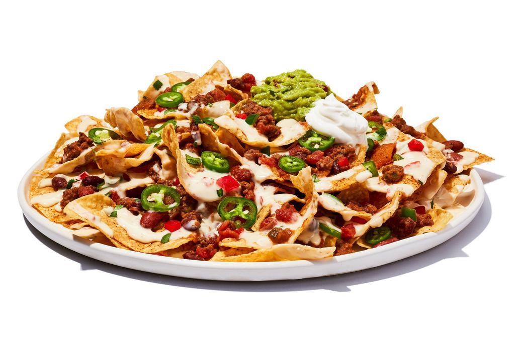 Tex Mex Nachos · You’ve struck gold. Tortilla chips loaded with cheese and chili, piled high with guacamole, lettuce, pico de gallo, jalapenos, sour cream and zesty chipotle sauce.