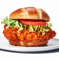Hooters Original Buffalo Chicken Sandwich · Hand-breaded chicken breast tossed in your favorite wing sauce, topped with lettuce and toma...