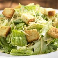 Caesar Salad · Chopped romaine, Parmesan cheese and crispy seasoned croutons with a creamy Caesar dressing.