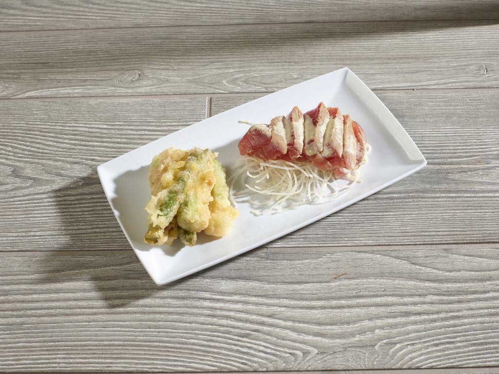 Ahi Tuna Asparagus · Seared tuna slices over cucumber and daikon radish, served with ponzu sauce and tempura asparagus on the side.
