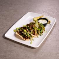 Ribeye street tacos · Thin sliced grilled ribeye on soft corn tortillas with shredded lettuce, avocado, and grille...