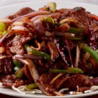 Mongolian Beef · Tender beef strips with sliced bell pepper, onion and carrots stir fried in  a spicy Mongoli...