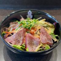 Tuna Tataki Salad · Thinly sliced seared tuna over organic mixed greens served with house-made ginger dressing.