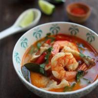Tom Yum Soup · Lemongrass and kaffir lime soup with Thai spices and mushrooms. Spicy.