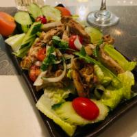 Thai Grilled Chicken Salad · Grilled Chicken slices tossed with Lettuce, Tomatoes, Cucumbers & Onions in Chili Garlic Lim...