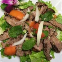 Thai Grilled Beef Salad · BBQ Beef Slices tossed with Lettuce, Tomatoes, Cucumbers & Onions in Chili Garlic Lime Dress...