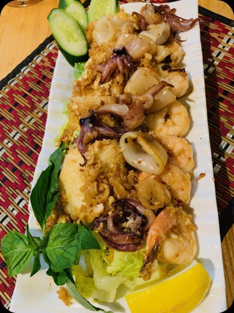 Garlic Seafood Medley · Sautéed Garlic Squid,  Shrimp, & Fish with Thai Seasoning and Sriracha Aioli