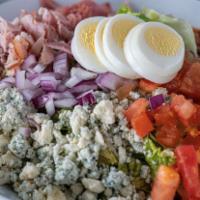 Classic Cobb Salad · Romaine and iceberg lettuce, turkey, ham,  bacon, avocado, tomato, onion, Black River blue c...