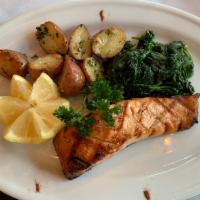 Salmone al Salmoriglio · Marinated grilled salmon served with sauteed spinach and roasted potatoes.