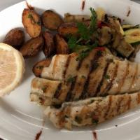 Branzino · Grilled mediterranean sea bass served with roasted potatoes and sauteed mixed vegetables.