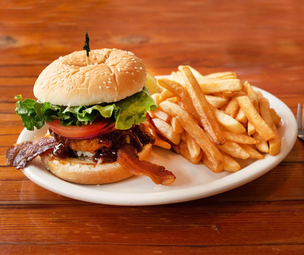 Cowboy Burger · Crispy bacon, Jack cheese, onion rings and BBQ sauce. Prepared with mayonnaise, lettuce, tomato, onion and pickles on a toasted sesame bun. Served with choice of side.