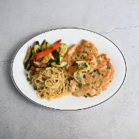 Chicken Piccata · Tender breast of chicken sauteed in lemon butter, white wine and capers, served with spaghet...