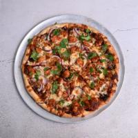 BBQ Chicken Pizza · Topped with red onions, cilantro and smoked mozzarella cheese.