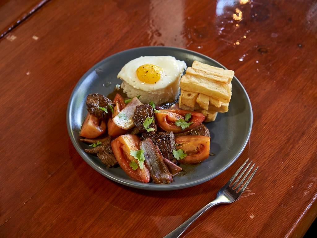Lima Lomo Saltado with Egg · Comes with traditional sunny side up egg. Traditional beef stir-fry with onion and tomato in a soy demi-glace. Served with french fries and white rice.