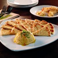 Hummus · Creamy hummus served with your choice of toasted pita wedges or carrots and celery. Garnishe...