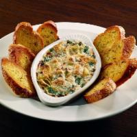 Spinach Artichoke Dip · Fresh sauteed spinach blended with artichokes, mozzarella and Parmesan in a creamy sauce top...